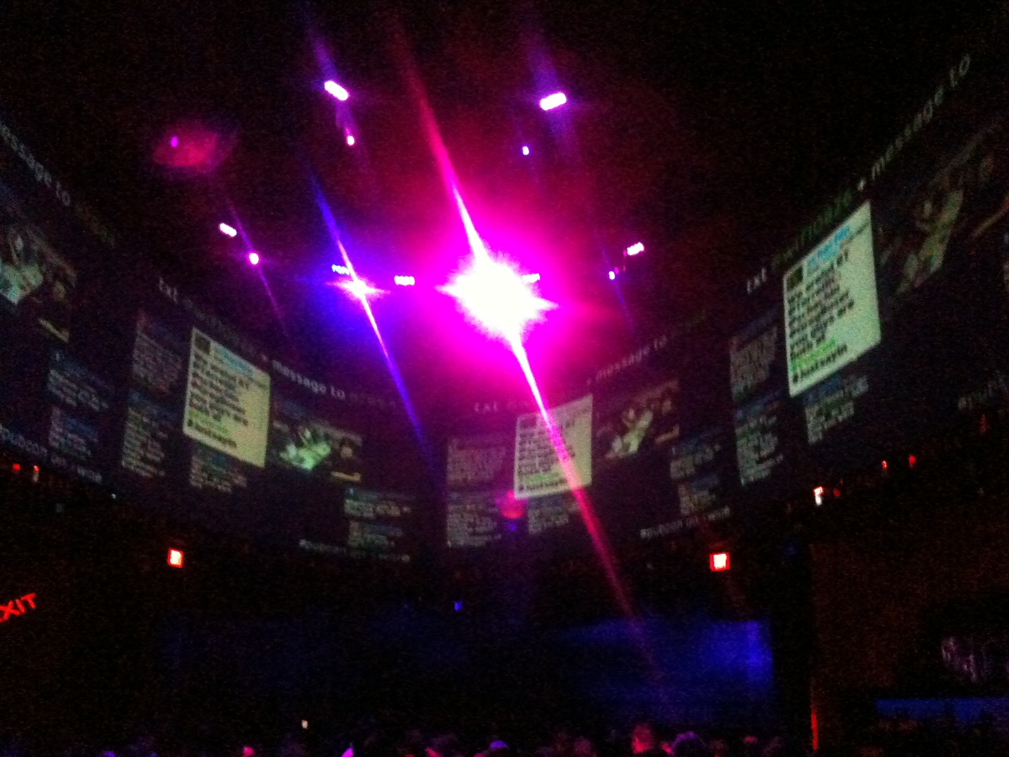 a large room filled with people sitting around on stage lighting