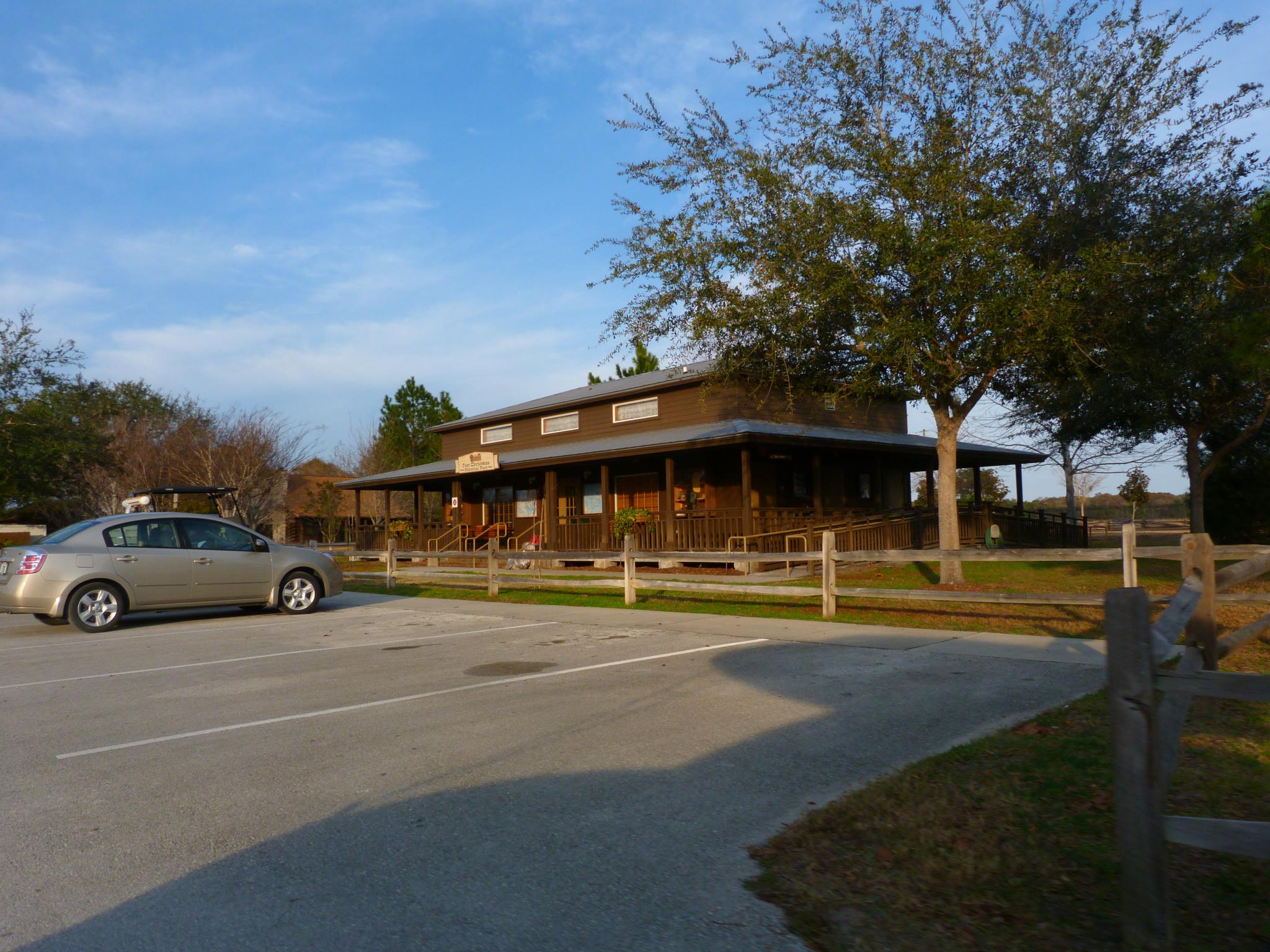 a car is parked outside a small wooden building