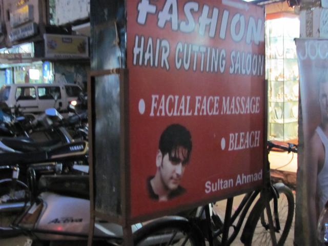 a street scene with an advertit for a hair  shop
