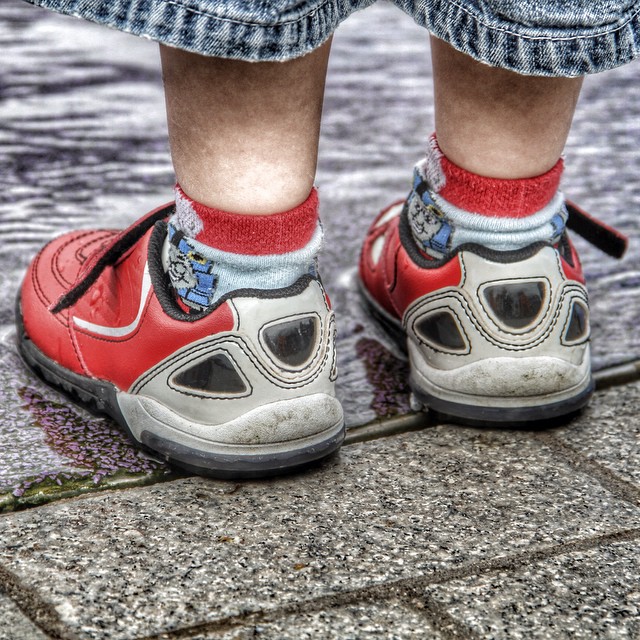 a close up of a persons shoes on a ground