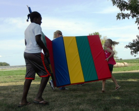 a  holding a colorful kite while another  holds the kite