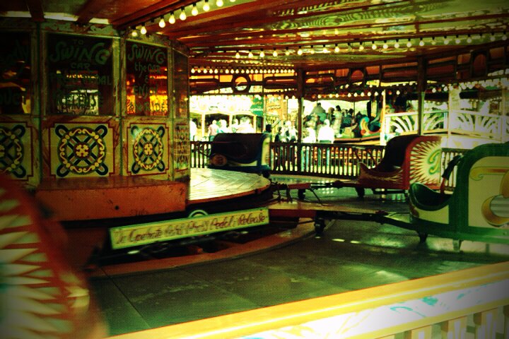 a carousel ride and seating area inside a building