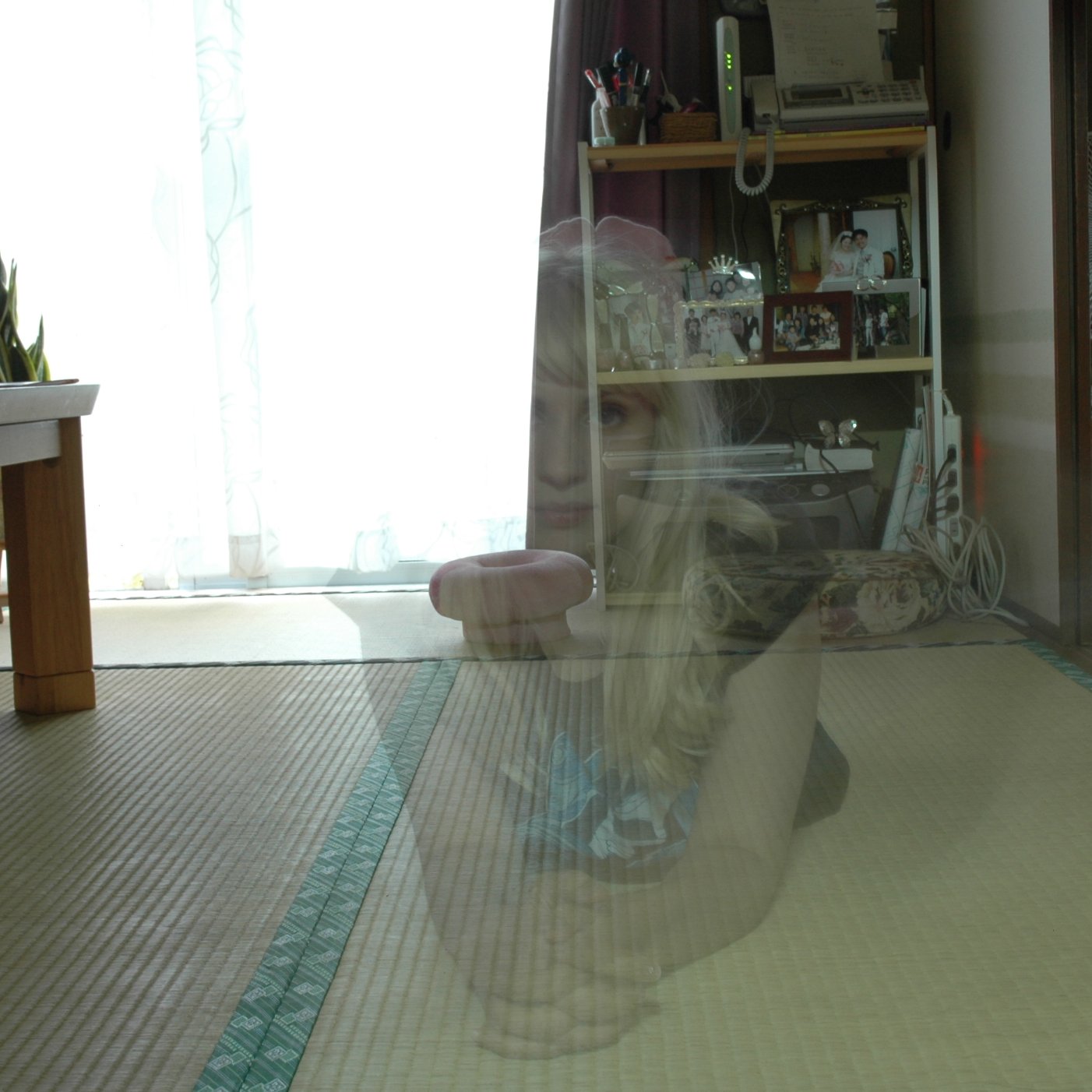 a young woman sitting in the window of her home