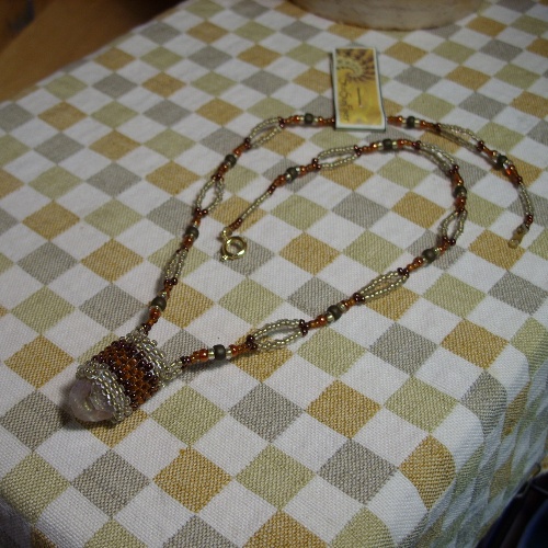 a necklace and tag sitting on a table