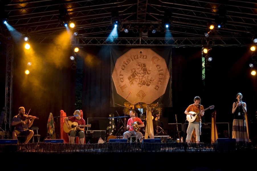 the band is performing on stage during the night
