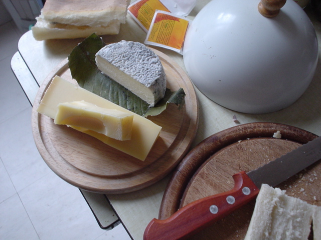 two cheese boards and a plate with cheese