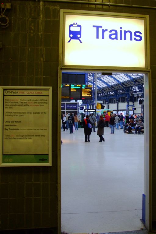 an open doorway leads into a railway station with a train
