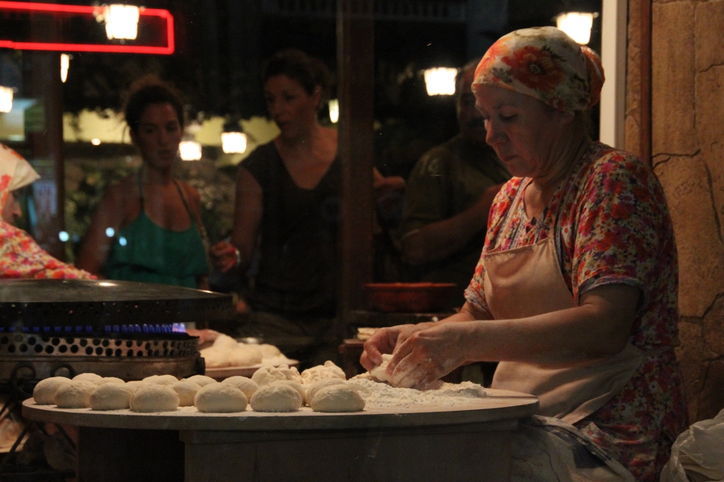 a woman is making appetizers at a restaurant