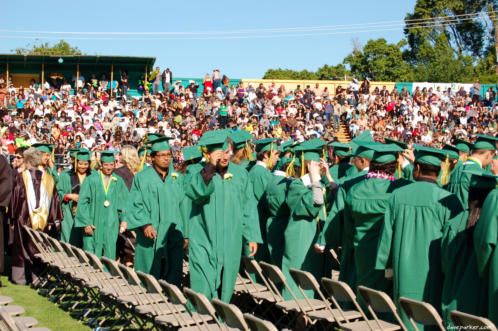 a group of graduates at graduation walking down the aisle