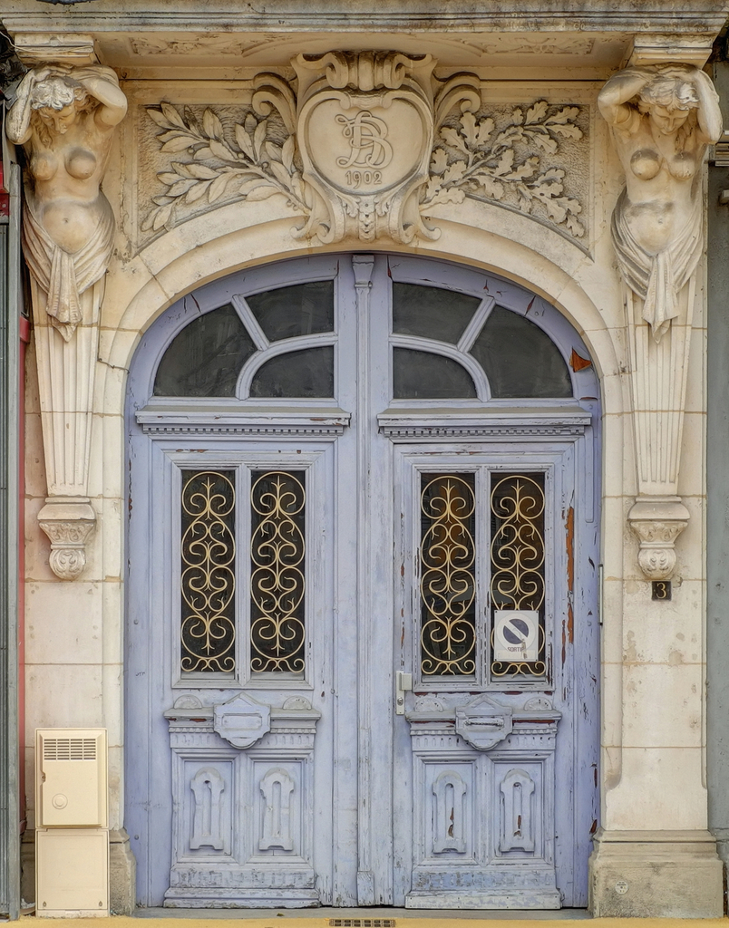 an old, ornate building with two big doors