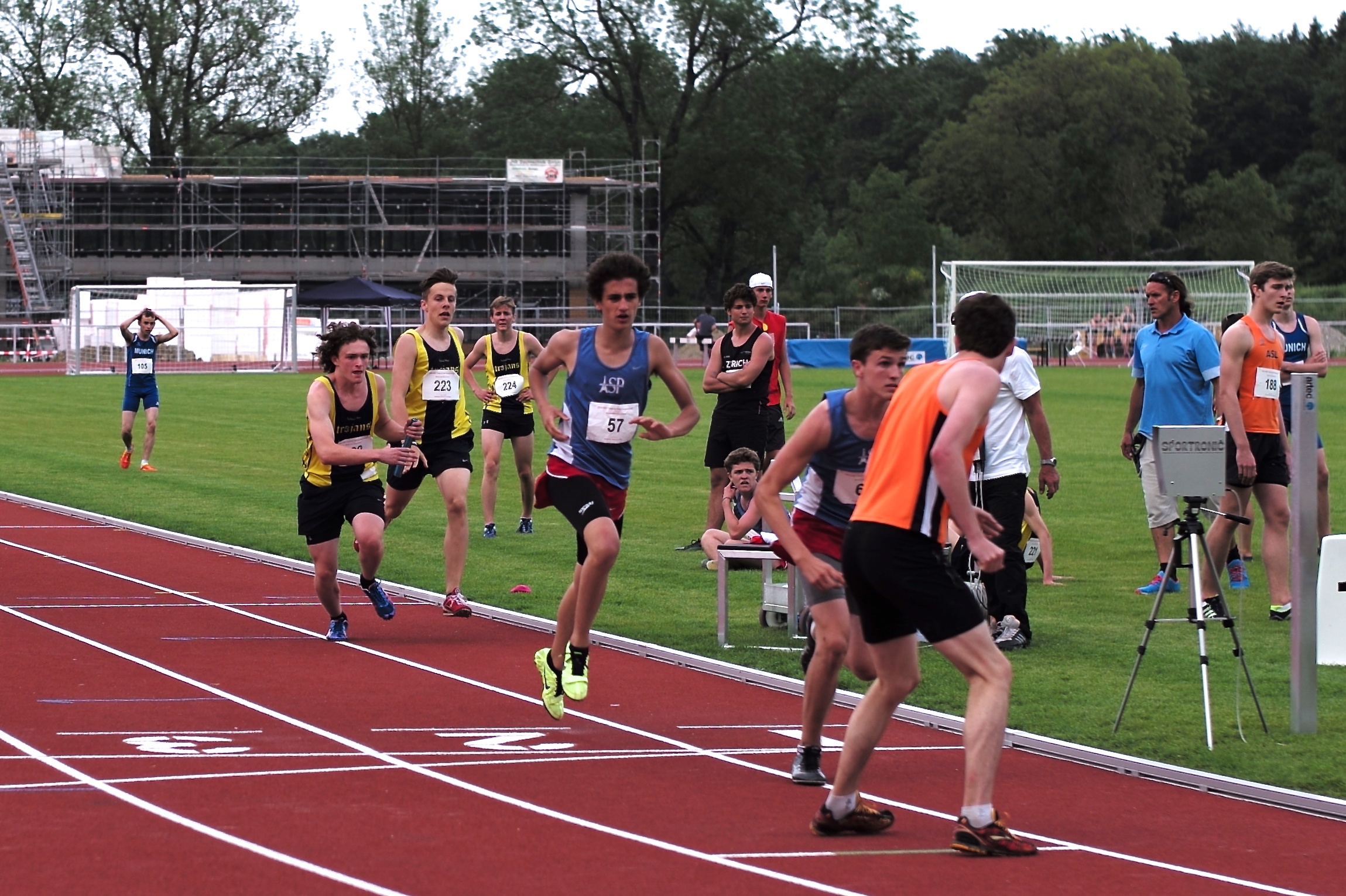 some athletes are running down the track at a track