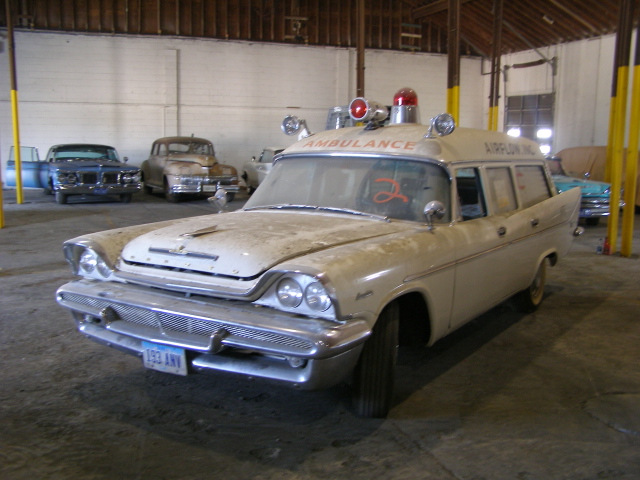 a vintage ambulance with some lights on the top of it