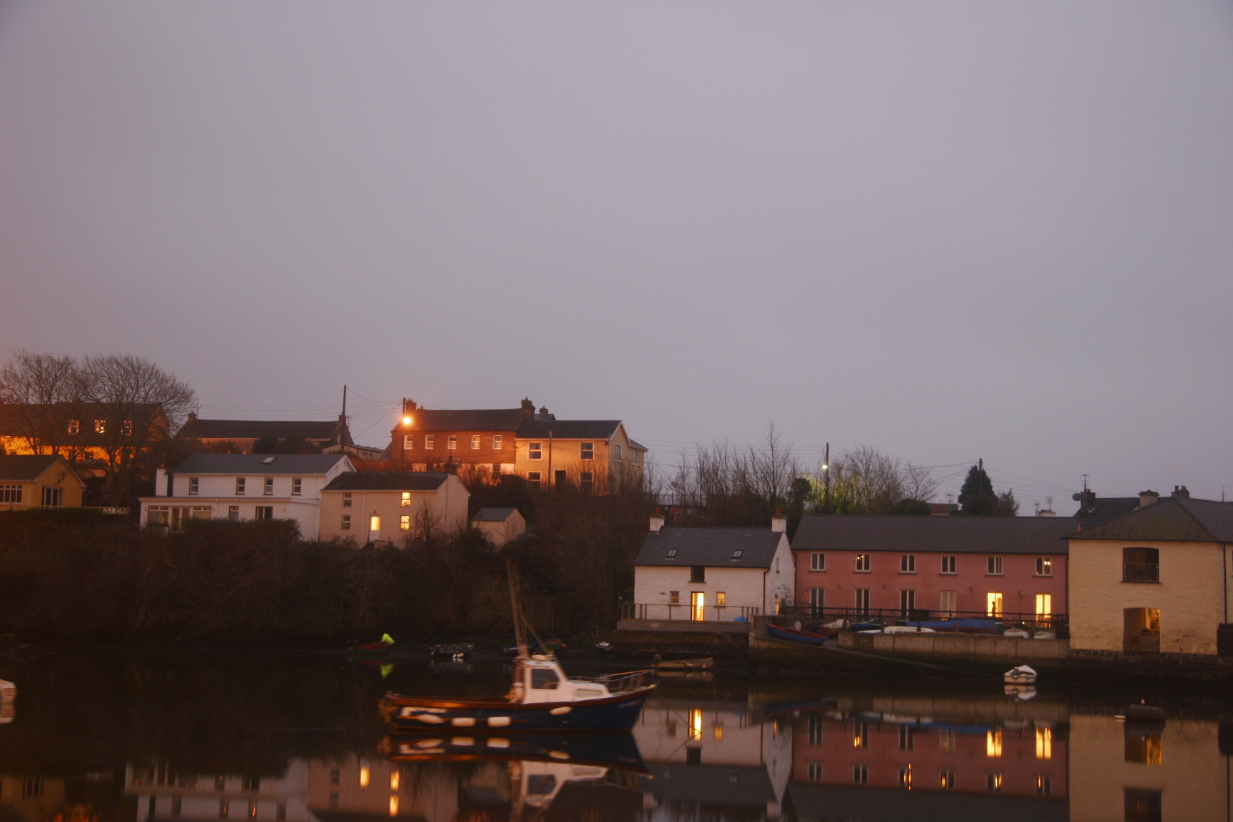 two boats are docked in a lake in front of town