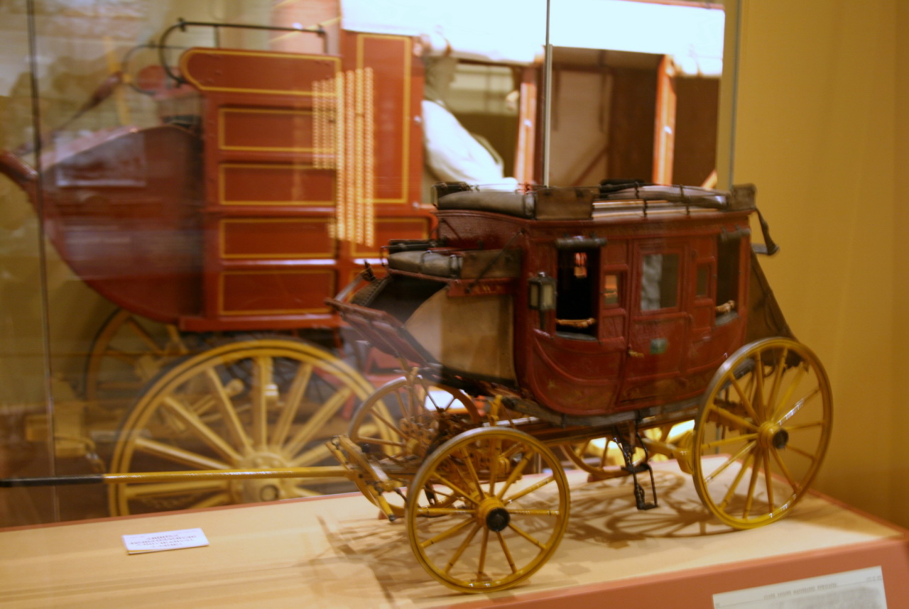 an old horse drawn carriage is sitting in the glass