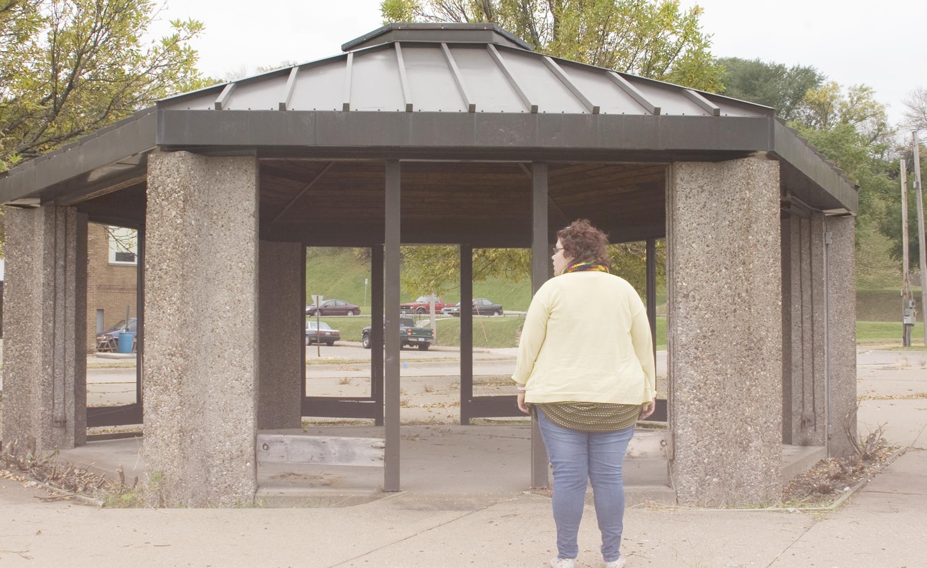 a woman is standing at an outdoor shelter