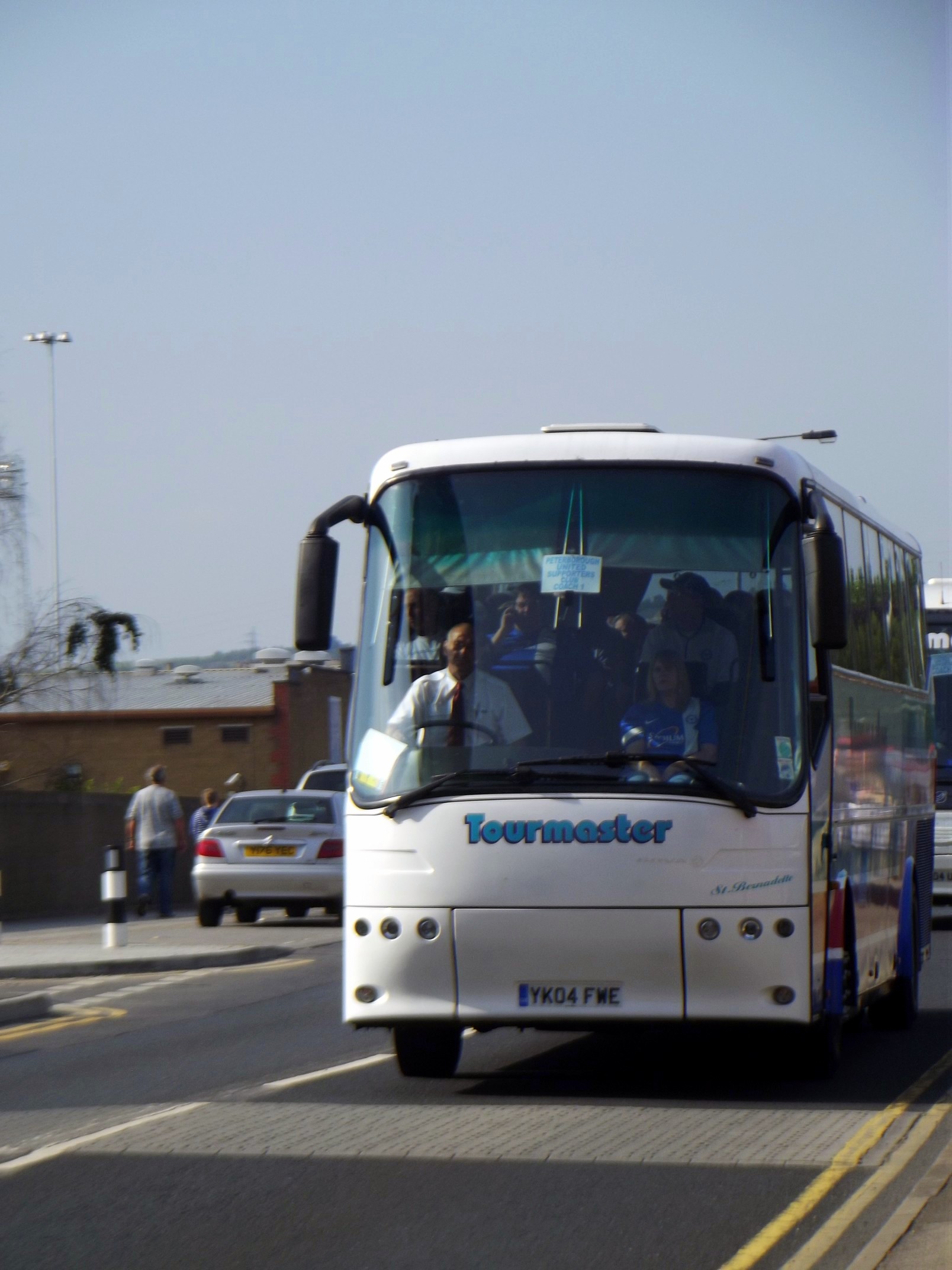 a bus with passengers traveling on the street