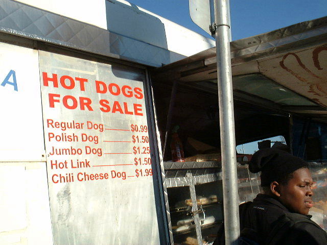 a black woman in front of a  dog stand