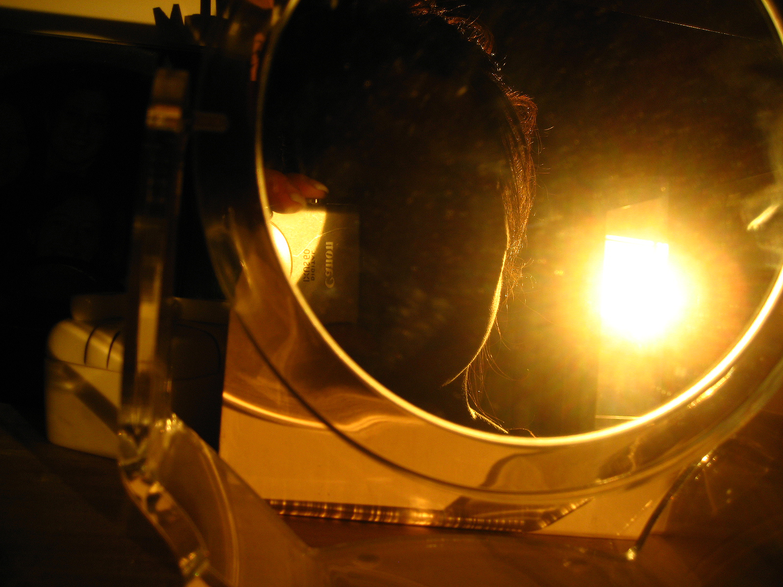 a close up s of the bright light behind a circular mirror