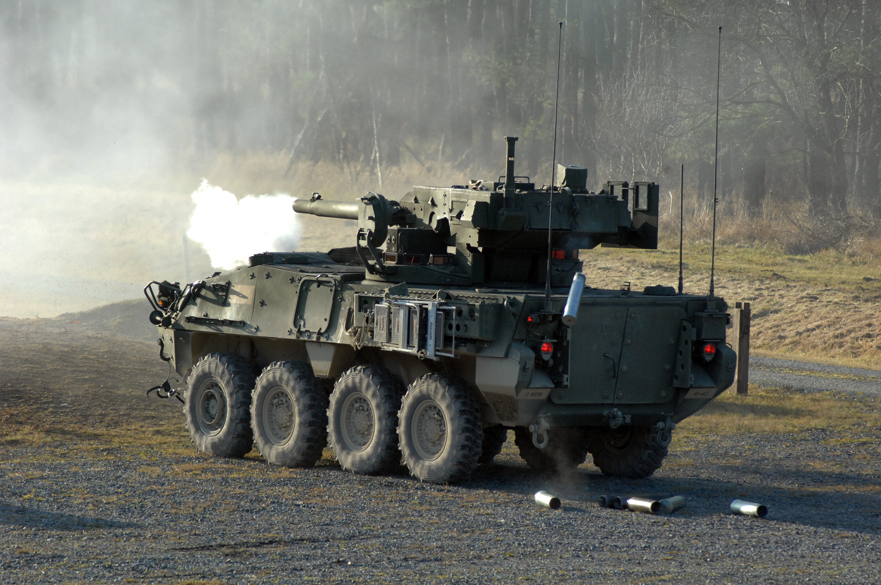 a large army vehicle on the road with its cannon fired