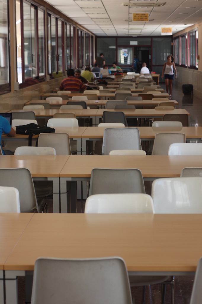 an empty classroom with desks and people inside