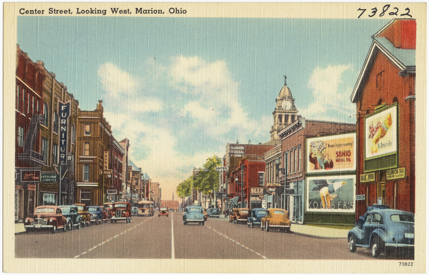 a postcard with a small group of cars driving in front of tall buildings