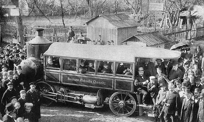 the old time picture shows people looking at an old fashioned bus