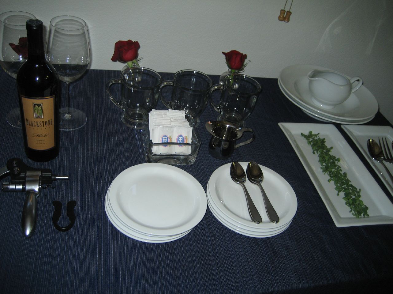 there is a place setting with wine and place settings