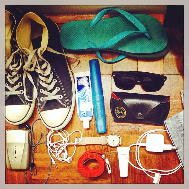 an image of the contents of a purse with some shoes and ear buds