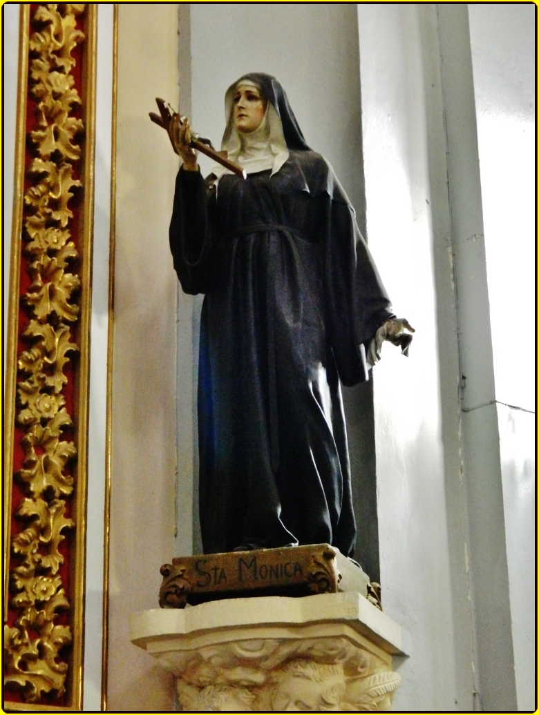 statue with white base in large building near golden decoration
