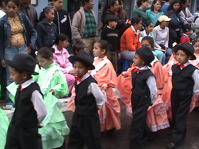 several small children in fancy dresses and hats