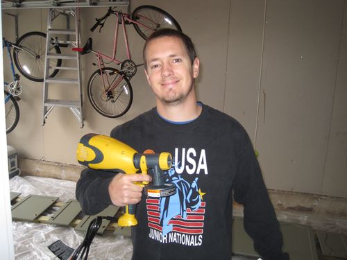 a man is holding a nail gun and standing by some bicycle racks