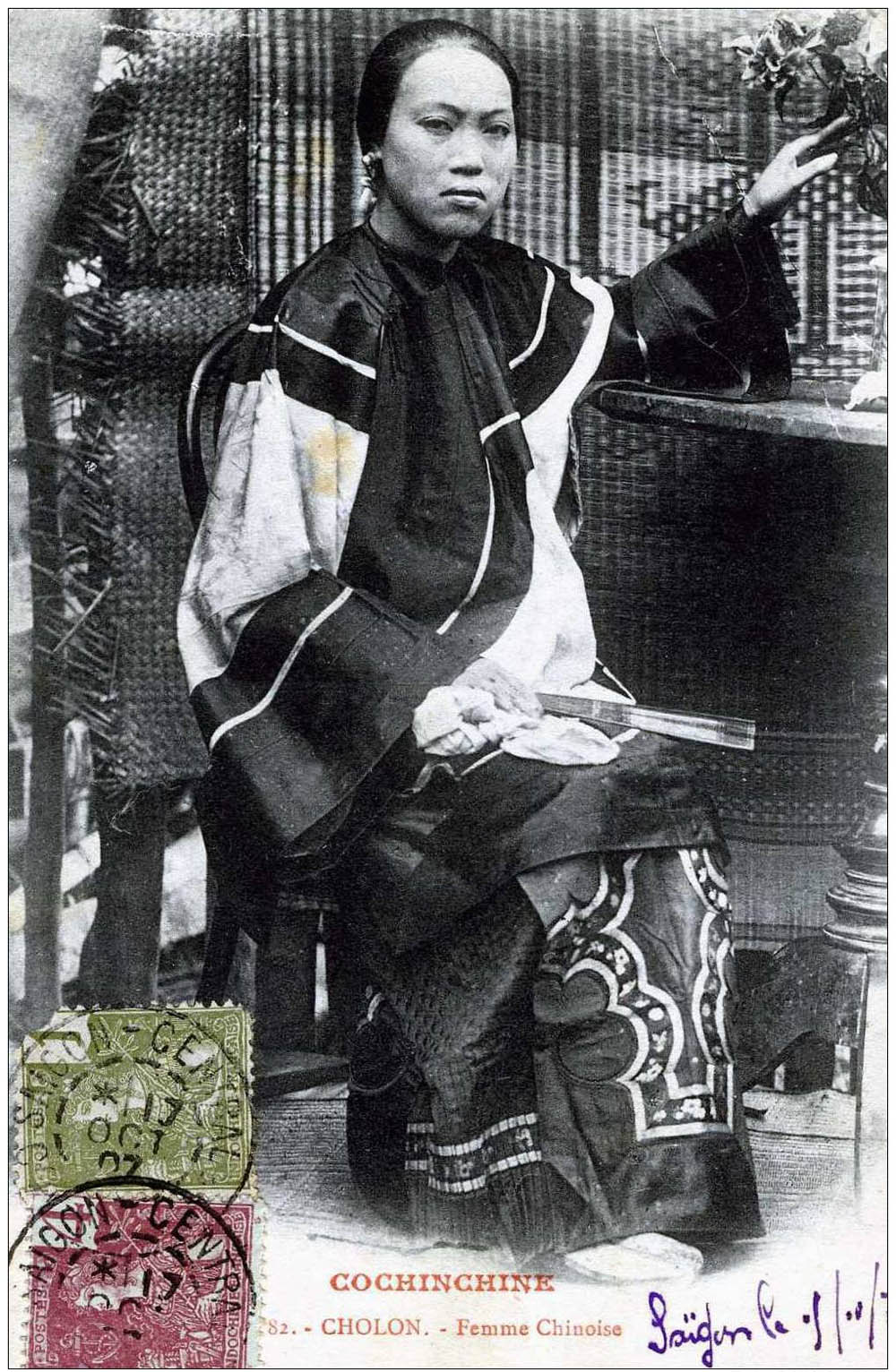 a woman sits in a chair with a book