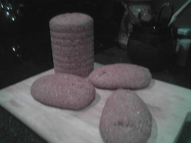the round pink sandels are stacked on a wooden board