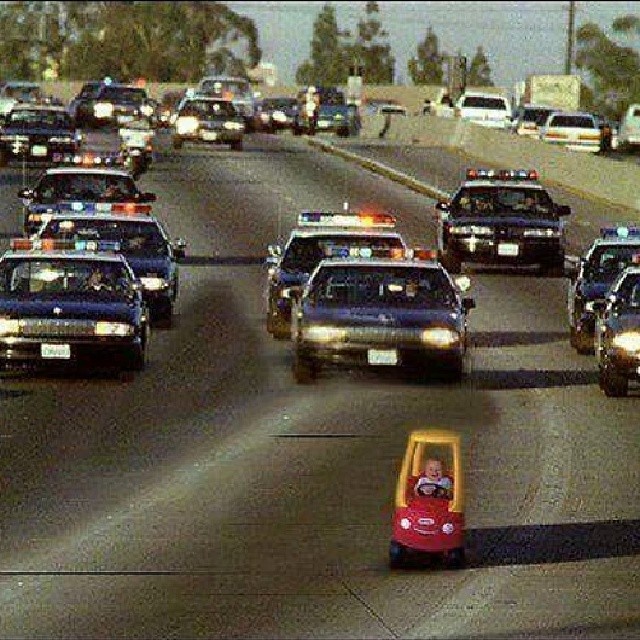 police car passing through a line of law enforcement cars