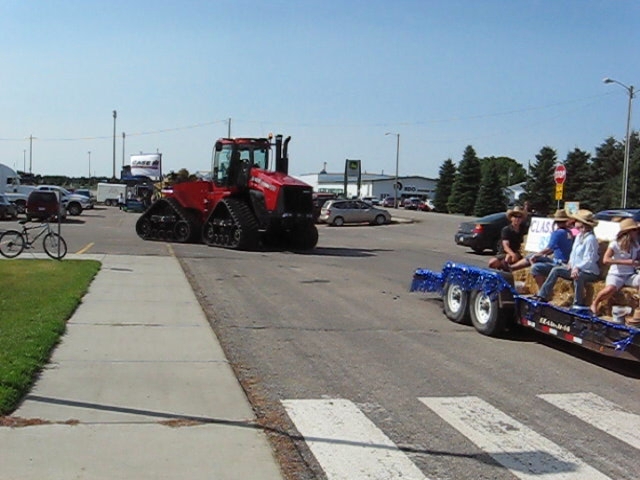 a large tractor pulling a trailer filled with people