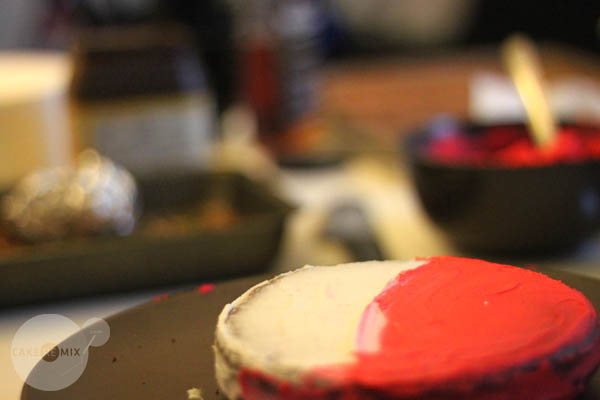 the red cake is covered in icing and ready to be eaten