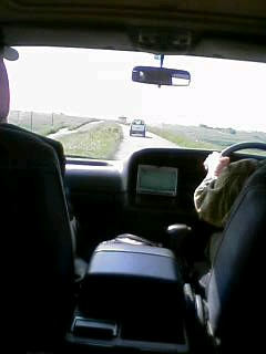 a driver is talking to a passenger in the passenger seat