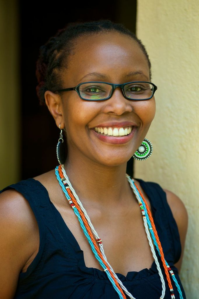 an image of a smiling woman wearing glasses