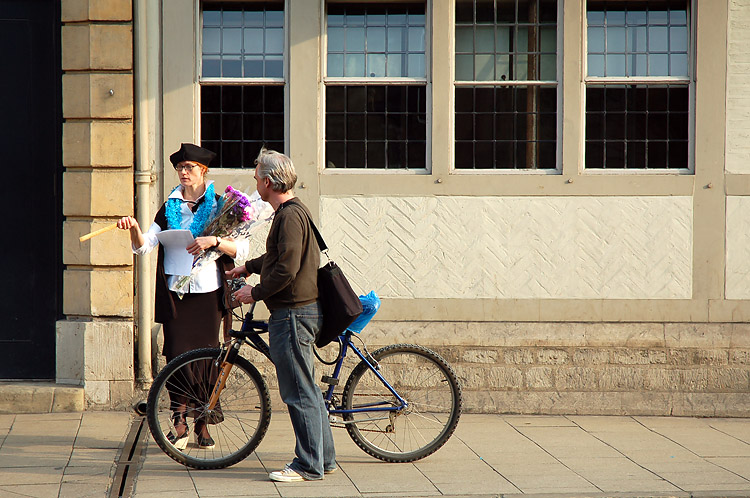 two people on a street with a bike