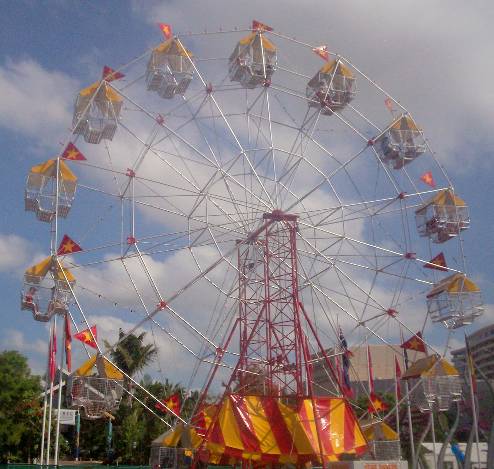 the big wheel is in the middle of the fair grounds