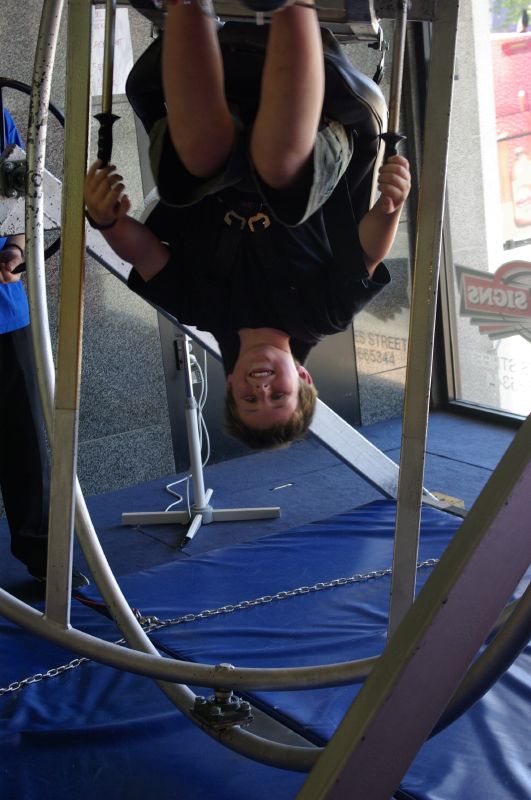 person standing on a board with their head on the bars