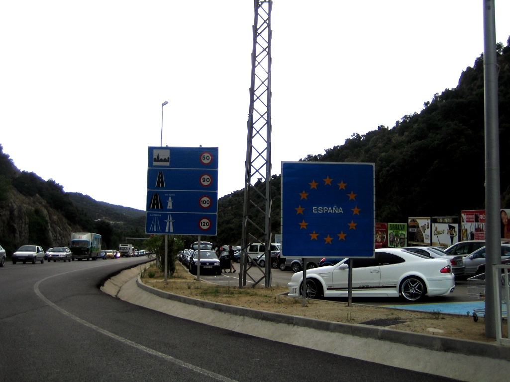 two signs, one blue and one red in europe and one blue on the road