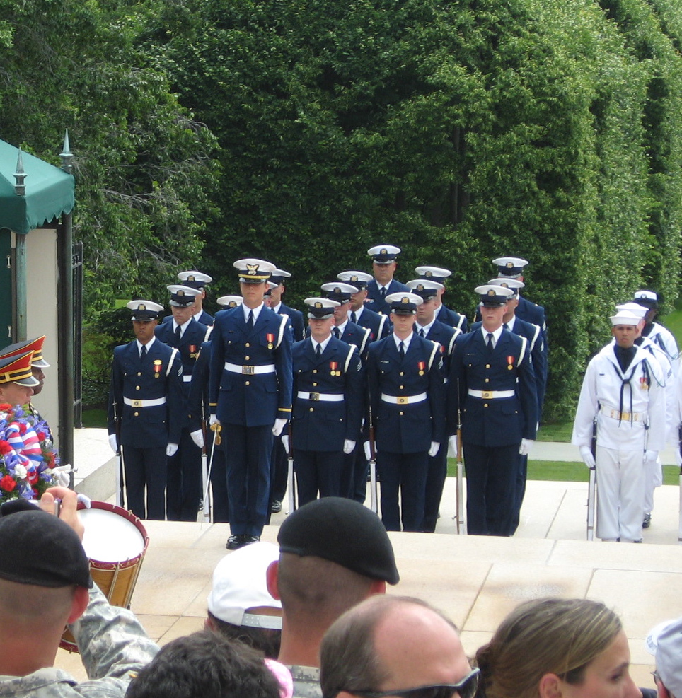 men dressed in blue and red are standing on stage near others