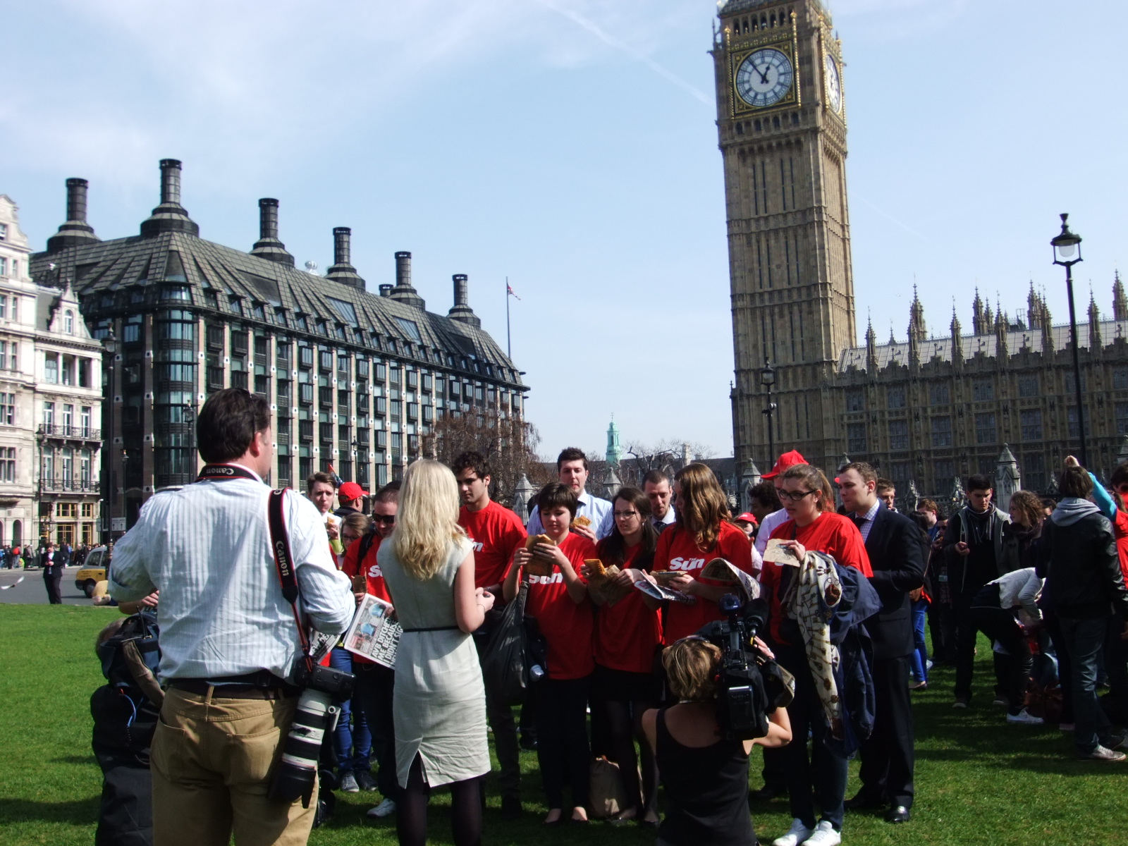 a large crowd of people standing next to a large tower