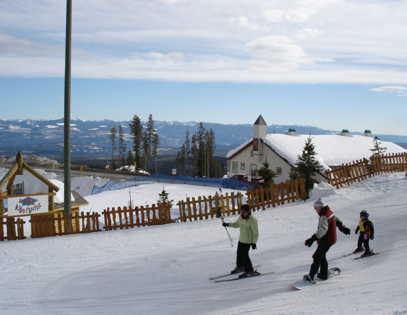 several people riding skis on a snowy surface