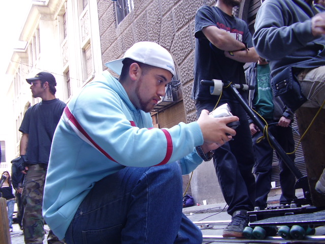 a man kneeling down while holding his hand in his pockets