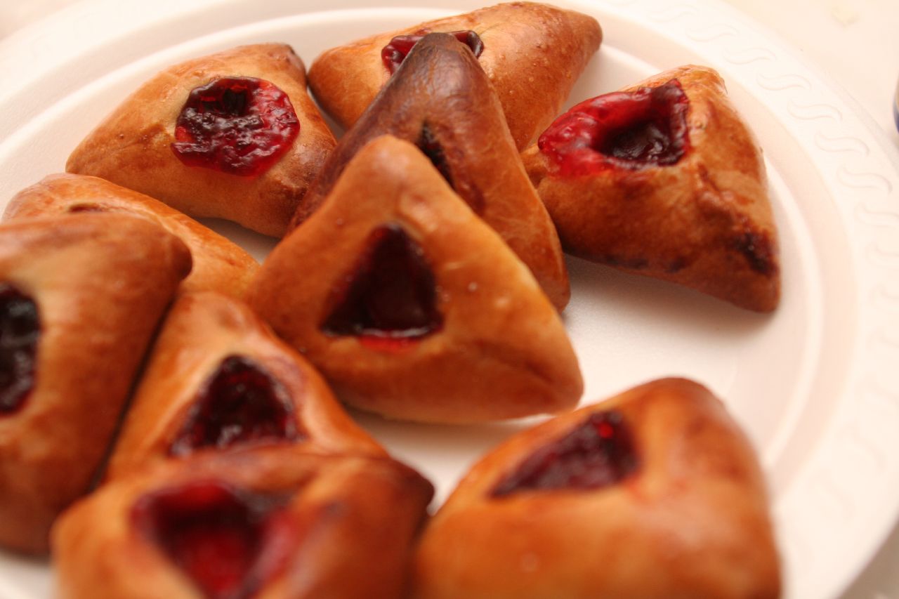 four pastries sit on a plate and each has a bite taken out