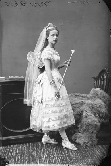 vintage po of bride in dress and veil holding sword