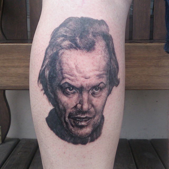 a black and white tattoo of a man with a funny look