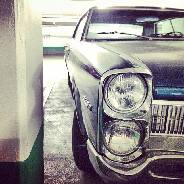 this old car is parked near the gas pump